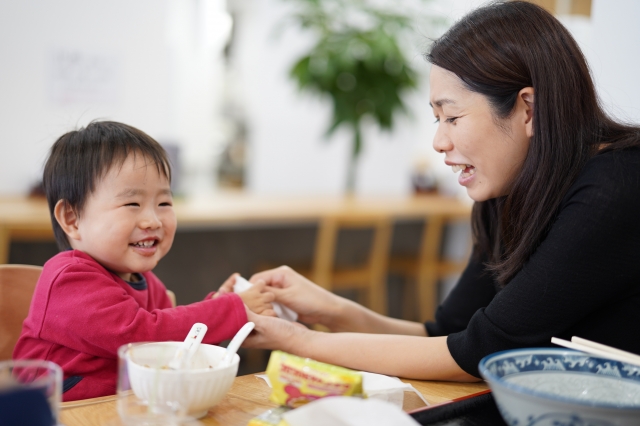 笑顔で食事をする親子